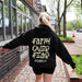 May include: Black hooded sweatshirt with the text "Faith Over Fear Psalm 27" in a cream color on the back.