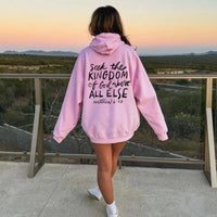 May include: Pink hoodie with a black graphic print that says "Seek the Kingdom of God above all else Matthew 6:33"